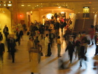 Grand Central Terminal main waiting room. Close up of still figures amongst the craziness. Photo taken from the west staircase.