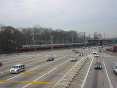 Northbound lanes @ New York State Thruway's New Rochelle Toll Barrier. The Northeast Corridor rail line is in the background, wi