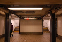 Fulton Street station complex, connection from the western IND mezzanine to the northbound BMT platform (lower level). View is l