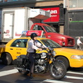 Suit on a motorcycle @ 23 St & 6 Av. Photo taken by Brian Weinberg, 8/1/2006.
