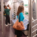 R-160B 8713 @ 42 St - Times Square (N) - interior. Left to right: shriek-boy and a passenger. Note: first revenue run of the R-1