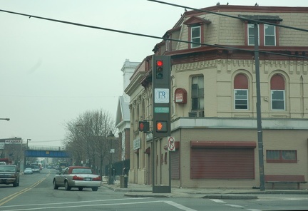 In the distance, the Staten Island North Shore right-of-way crossing over Port Richmond Avenue. Photo looks south. Photo taken b