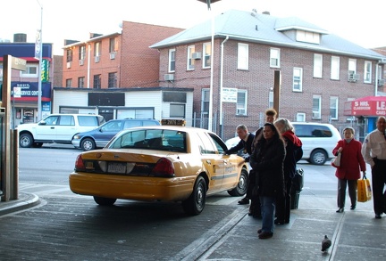 Taxi cab in a bus lane at the Victor Moore Arcade bus station @ 74 St - Broadway and/or Jackson Heights-Roosevelt Avenue (7/E/F/