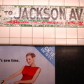 Painted &quot;Jackson Av&quot; directional sign @ 21 St - Van Alst. Note that the tiles underneath actually say &quot;47th Ave