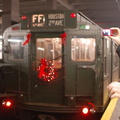 R-1 100 @ Lower East Side - 2 Av (V). Note the enthusiastic rider snapping a photo with his tiny stylish digital camera. Photo t