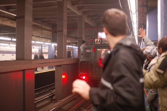 R-1 100 @ Lower East Side - 2 Av (V). Note the excited railfan waving goodbye to the beloved train. Photo taken by Brian Weinber