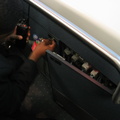 JFK AirTrain agent plays with some electrical stuff in a cabinet beneath the closed manual operation control stand. Something wa