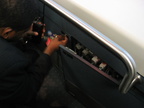 JFK AirTrain agent plays with some electrical stuff in a cabinet beneath the closed manual operation control stand. Something wa