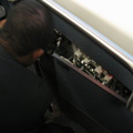 JFK AirTrain agent plays with some electrical stuff in a cabinet beneath the closed manual operation control stand. Something wa