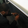 JFK AirTrain agent plays with some electrical stuff in a cabinet beneath the closed manual operation control stand. Something wa