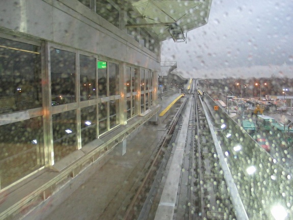 View out the HUGE railfan window of an outbound AirTrain stopped at the Federal Circle station.