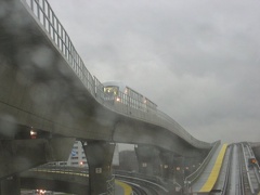 View out the HUGE railfan window of a Jamaica bound AirTrain climbing the hill after just leaving at the Federal Circle station.