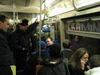 Woman who had to call her friend to tell her she was on the first (D) train and it had a ton of train buffs on it