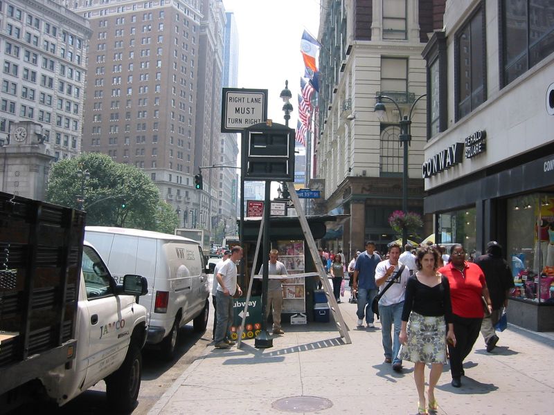 34th Street Partnership subway sign on the west side of Broadway, just north of 35 St. Photo taken by Brian Weinberg, 7/22/2004.