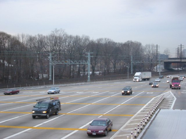 Northbound lanes @ New York State Thruway's New Rochelle Toll Barrier. The Northeast Corridor rail line is in the background.