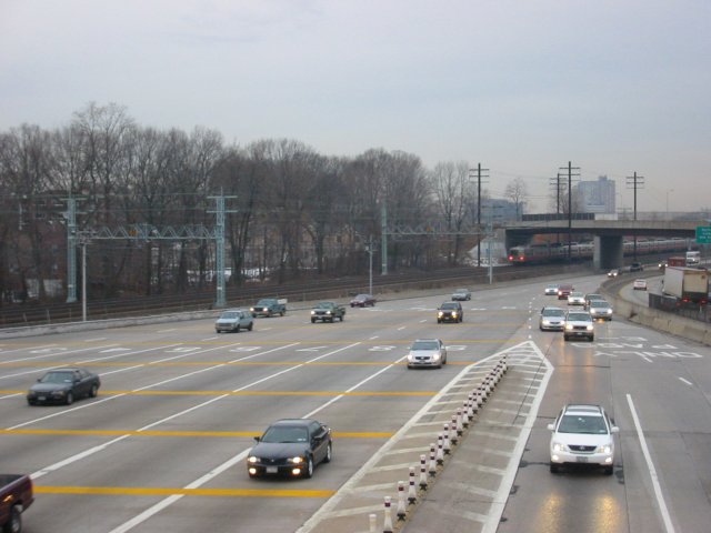 Northbound lanes @ New York State Thruway's New Rochelle Toll Barrier. The Northeast Corridor rail line is in the background, wi