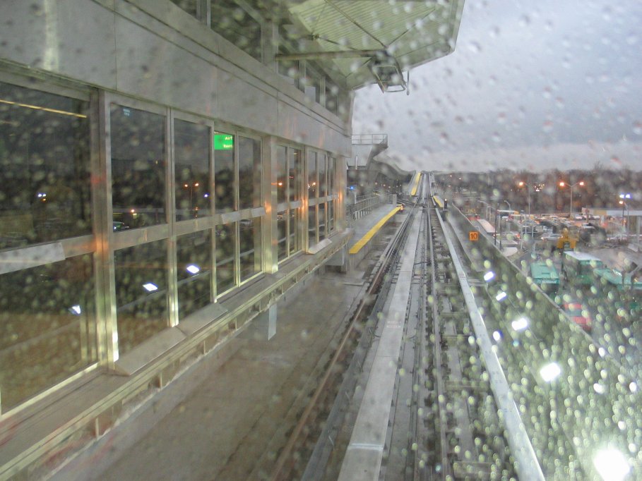 View out the HUGE railfan window of an outbound AirTrain stopped at the Federal Circle station.