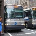 MTA Bus MCI D4501 7425 (ex-NYBS 1803) and MCI D4500CL 3041 @ 42 St & 5 Av. Photo taken by Brian Weinberg, 7/27/2006.