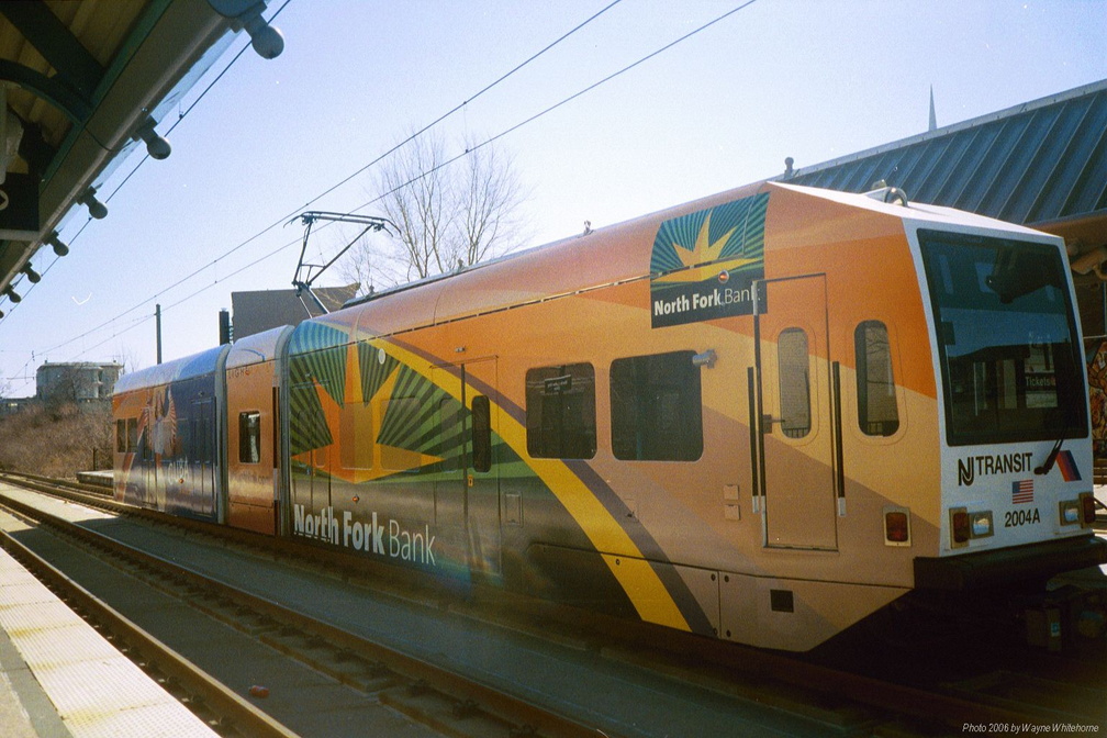 NJ Transit HBLR LRV 2004A @ MLK BLVD. Note the North Fork bank wrap. Photo taken by Wayne Whitehorne, 3/11/2006.