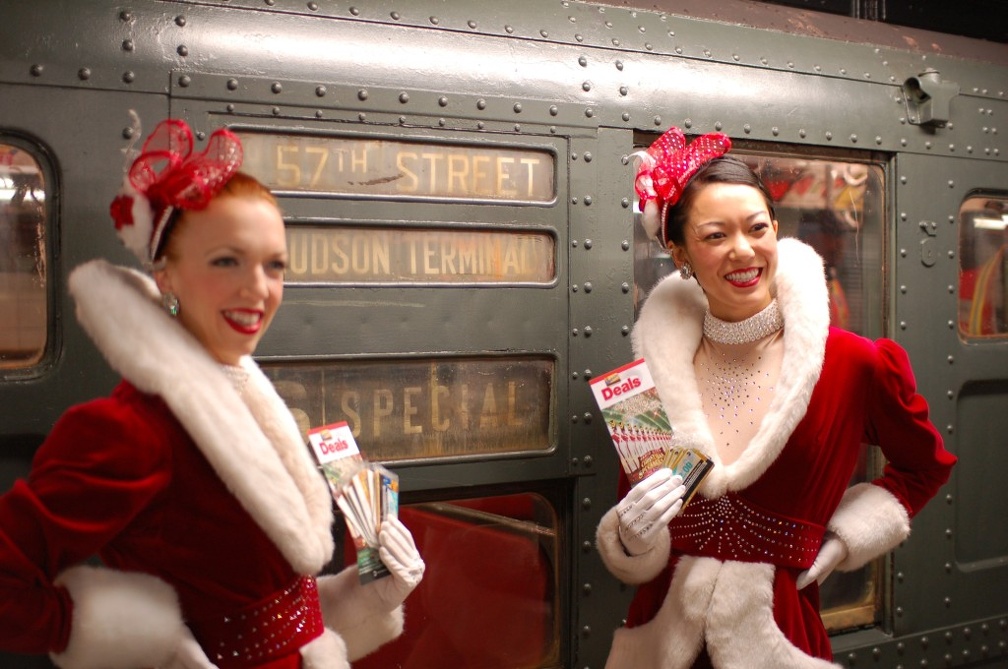 Rockettes Lauren Gaul, left, and Naomi Hubert ride the Arnines in service (incl. R-6 1300).