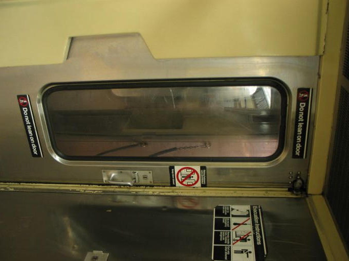 Interior of R-40 4253 @ 59 St-Columbus Circle (B). Note the rubber seal around the storm door window and the lack of a metal fra