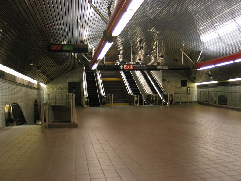 Looking west towards escalators on mezzanine one level above the platforms @ Roosevelt Island (F). Photo taken by Brian Weinberg, 5/30/2004. IMG_0697.jpg