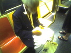 This guy that does pencil drawings of people on the subway (on a 1 train). Photo taken by Brian Weinberg, 9/14/2005.