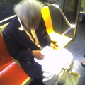This guy that does pencil drawings of people on the subway (on a 1 train). Photo taken by Brian Weinberg, 9/14/2005.