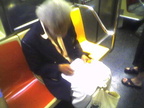 This guy that does pencil drawings of people on the subway (on a 1 train). Photo taken by Brian Weinberg, 9/14/2005.