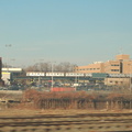 A train of R-62A cars travels north along the route of the (1) just south of the Broadway Bridge. The train is out-of-service as