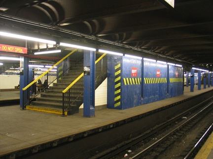 Temporary wooden shed built on to the back of a staircase on the center platform @ 59 St-Columbus Circle. Photo taken by Brian W