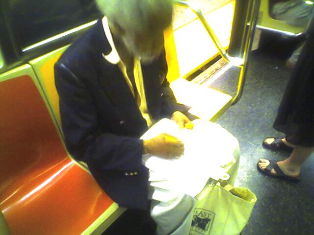 This guy that does pencil drawings of people on the subway (on a 1 train). Photo taken by Brian Weinberg, 9/14/2005. Picture029_14Sep05.jpg